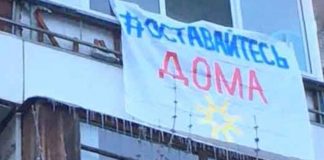 Muscovites hang out on the balconies, and flags calling to stay home