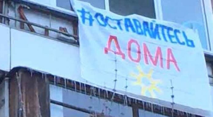 Muscovites hang out on the balconies, and flags calling to stay home